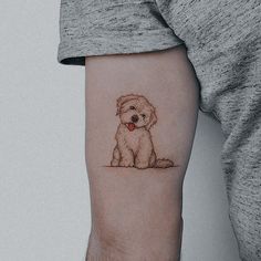 a small dog tattoo on the left inner forearm and arm, with a red heart in it's mouth