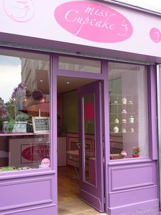 a purple store front with the door open