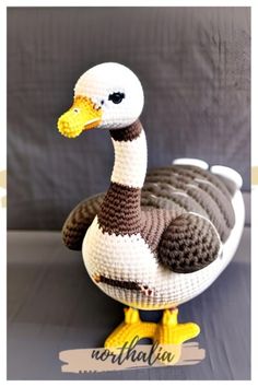 a knitted duck sitting on top of a table