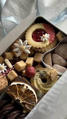 a box filled with lots of different types of cookies and pastries next to each other