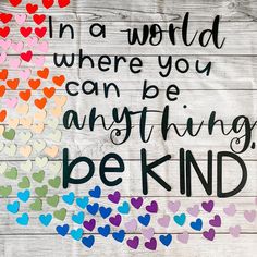 a sign that says in a world where you can be anything, be kind with hearts