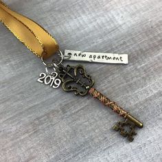 a key is attached to a gold ribbon