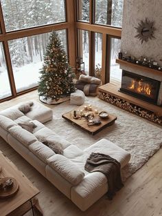 a living room filled with furniture and a christmas tree in the corner next to a fire place