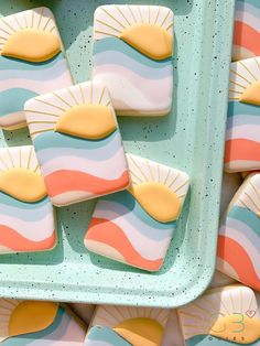 colorful cookies are arranged in the shape of sunbursts on a blue tray