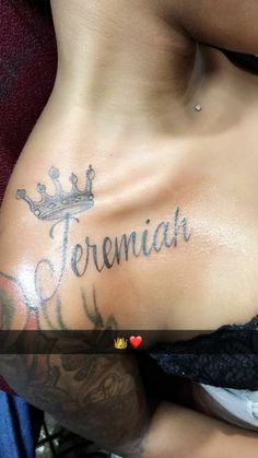 a woman with a crown tattoo on her stomach and the word treemah written in cursive writing