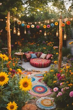 an outdoor seating area with sunflowers and other flowers in the background is lit by string lights