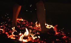 a person standing on top of a pile of fire