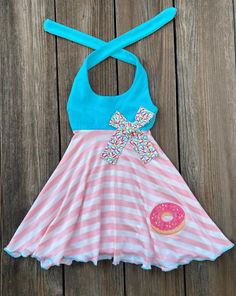 This cute custom boutique donut dress would be perfect for a donut themed birthday party or just a fun day out in the sun. Top bodice is aqua, skirt panel is pink white stripe with a sprinkle donut on front. Check out are donut theme section for a variety of outfits and dresses for little girls. Donut Sprinkle, Donut Dress, Sprinkle Birthday, Donut With Sprinkles, Bug Clothing, Donut Themed Birthday Party, Little Mermaid Dresses, Chic Shack, Sprinkle Donut