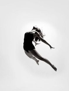 a woman flying through the air while riding a skateboard in front of a white background