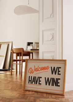 a welcome we have wine sign sitting on the floor