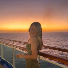 a woman standing on the deck of a cruise ship