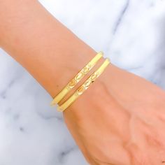 This exquisite pair of 22k gold bangles weighs a total of 26.8 grams and features a reflective triple marquise design that adds a touch of sophistication. The yellow gold finish enhances their elegant appearance, making them a perfect choice for those who appreciate classic beauty with a modern twist. Sized at 2.8 with a 2.5-inch opening diameter, these bangles offer a comfortable fit. Whether worn for special occasions or as a statement piece for daily wear, these bangles are a versatile and stylish addition to any jewelry collection. PRODUCT DETAILS Gold Purity(karat): 22k Gold Weight(grams): 26.8 Item Finish: Yellow Gold Bangle Size: 2.8 Bangle Opening(diameter): 2.5" Number Of Pieces: 2 Bangles 22k Gold Bangles, Bridal Jewelry Necklace, Precious Stones Rings, 5 Number, Diamond Pendant Sets, Modern Bracelets, Yellow Gold Bangle, Fancy Necklace, Fancy Rings