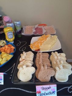 a table topped with trays of food covered in cheese and other foodstuffs