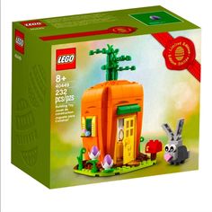 a box with an orange house and two rabbits