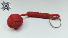 a red rope is tied to a metal hook