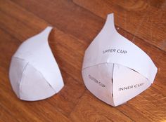 two pieces of paper sitting on top of a wooden floor next to each other with the words inner cup cut out