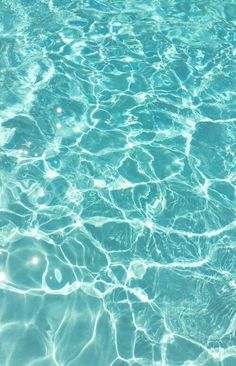 the water is very clear and blue in this swimming pool with ripples on it