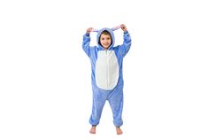 a little boy in a blue animal onesuit is holding his hands up to his head