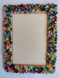 a wooden frame filled with lots of different colored beads