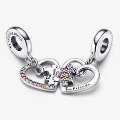 Crafted in sterling silver, the Puzzle Piece Hearts Splittable Friendship Dangle Charm serves as a reminder that friends complete us. Designed for sharing, it features two dangles that combine a cutout heart with a puzzle piece - both are decorated on one side by an array of colourful stones. The bail is engraved with a message: "My Missing Piece." Give one to your bestie and join the pieces whenever you’re together to connect in a whole new way. - Pandora Puzzle Piece Hearts Splittable Friendsh Colourful Stones, Carved Heart, Bracelet Charms