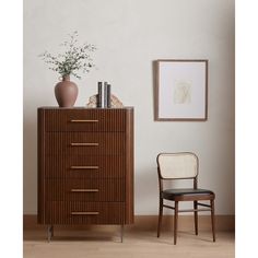 a chair sitting next to a tall wooden dresser