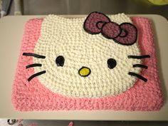 a cake that looks like hello kitty on top of a white plate with pink trim