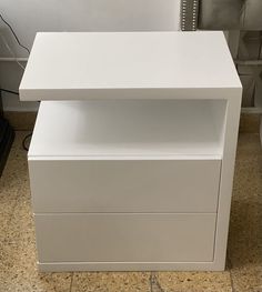 a white desk with two drawers on top of it