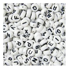 white beads with black letters on them