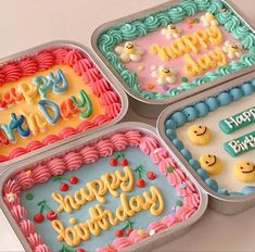 four birthday cakes in tins with happy birthday written on the frosting and decorations