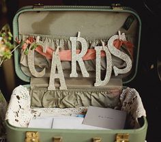 an open suitcase filled with cards and flowers