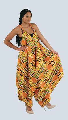 Kente Jumpsuit - This comfortable and classy jumpsuit has a bold, traditional kente print of yellow and orange. Show your love of authentic African culture and style with this unique Kente-cloth print jumpsuit. #womensfashion #fashion #jumpsuit #ethnicfashion #africanfashion #womenstyle #womensapparel #style #yellow #womensapparel #africanstyle #africa #african #kente #ethnicapparel #orange #stylish Kente Jumpsuit, Afro Clothes, Style Salopette, Palazzo Jumpsuit, Kente Print, Classy Jumpsuit, Ethno Style, Afrikaanse Mode, Kente Cloth