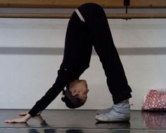 a person doing a handstand on the floor