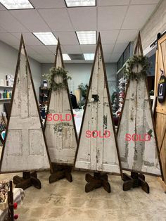 three wooden christmas trees sitting on top of each other