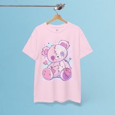 ✦ OUR PRODUCT Embrace your soft side with a hint of edge in this Stitched Teddy Bear t-shirt! Featuring an adorable pastel-colored teddy bear with stitched details and cute little hearts, this design brings a perfect blend of sweet and quirky vibes. Made from durable 100% US cotton, this unisex t-shirt is comfortable for everyday wear while standing out with its playful, pastel goth style. Whether you're into cute designs or alternative fashion, this tee adds a unique, whimsical touch to your wa Kawaii Anime Print T-shirt For Streetwear, Pink Cotton Emo T-shirt, Pastel Goth Cotton Short Sleeve Tops, Pink Short Sleeve Emo Tops, Kawaii Cotton T-shirt With Anime Print, Kawaii Anime Print Cotton T-shirt, Pink Harajuku T-shirt With Anime Print, Pink Harajuku Style Anime Print T-shirt, Pink Emo Style Cotton T-shirt