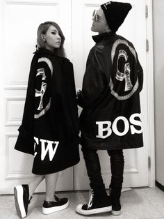 two women wearing jackets with the words boss and w on them, standing in front of a door