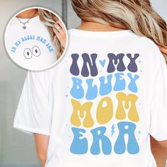 a woman wearing a t - shirt that says, in my blue mom era on it