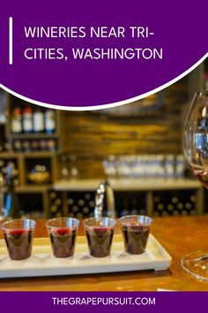 wine glasses on a tray with the words wines near tri - cities, washington above it