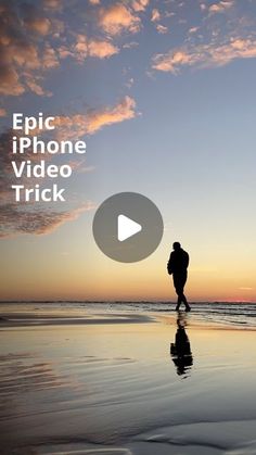 a man walking on the beach at sunset with an iphone video trick in front of him