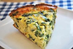 a slice of quiche on a white plate