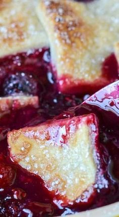 a close up of a pie with berries in it