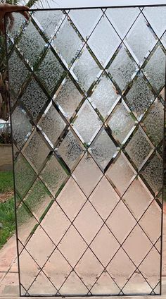 a large mirror sitting on top of a sidewalk