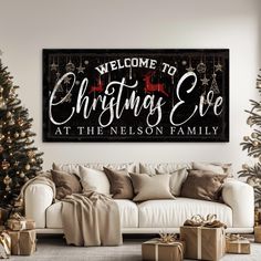 a living room with christmas decorations and presents on the floor next to a white couch