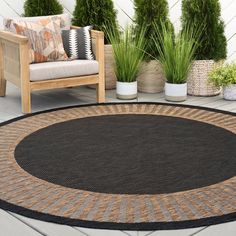 an outdoor area rug on the ground with potted plants