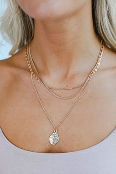 The Gia Gold Hammered Charm Layered Chain Necklace is the perfect combo of sleek and classic! This trendy necklace features three layers of gold chains with a hammered charm on the end. Style the Gia Necklace with any outfit to instantly add a chic touch to your look! Gold Plated Layered Hammered Charm Lobster Clasp with Extender Layer 1 | Length 9.5" Layer 2 | Length 7" Layer 3 | Length 7" Extender | Length 3" 2024 Accessories, From Dress, 7 Layer, Layered Chain Necklace, Layered Chain, Trendy Necklace, Cute Accessories, Cute Handbags, Layered Chains