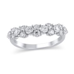 a white gold ring with five stones on the side and two rows of diamonds in each band