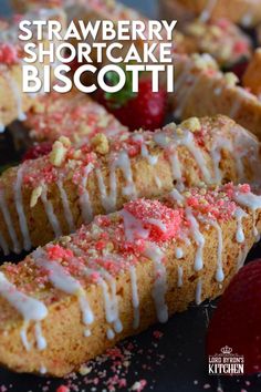 strawberry shortcake biscotti with white icing and strawberries on the side