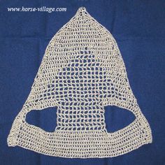 a white crocheted mask on a blue background