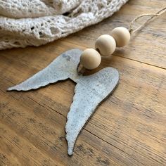 an angel wing with three eggs on it