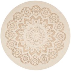 a round rug with an intricate design on the center and bottom, in beige tones