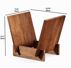 two wooden bookshelves sitting on top of each other with measurements in front of them